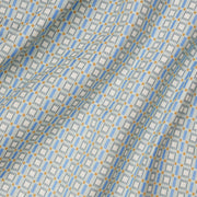 A close-up view of a fabric with a geometric pattern featuring blue and yellow colors.