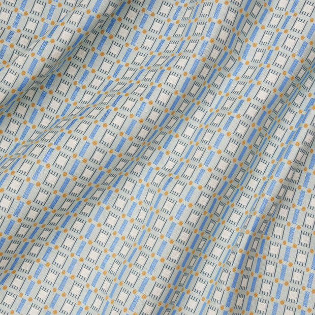 A close-up view of a fabric with a geometric pattern featuring blue and yellow colors.