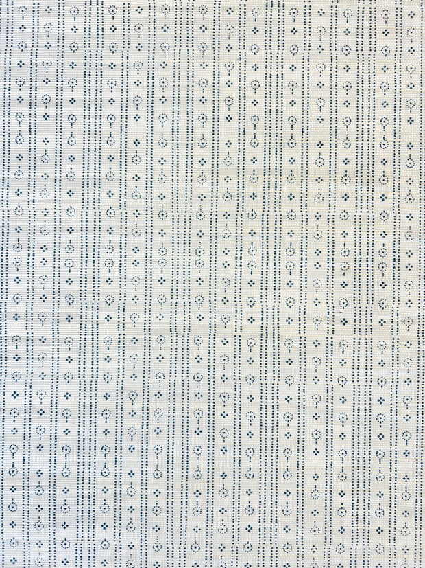 A close-up view of a section of wallpaper with a geometric pattern featuring diamond shapes in beige and blue colors - Ice Navy Grasscloth Wallpaper – Birdlip Path Collection | Natural Wallcovering