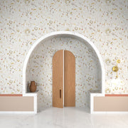 Decorative interior with an archway, wooden door, and patterned wallpaper.