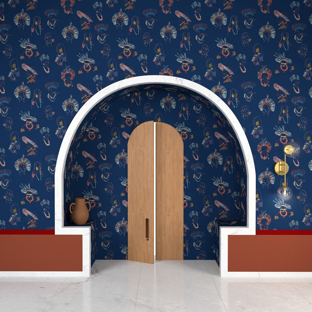 Room with blue patterned wallpaper, wooden door, and white archway.