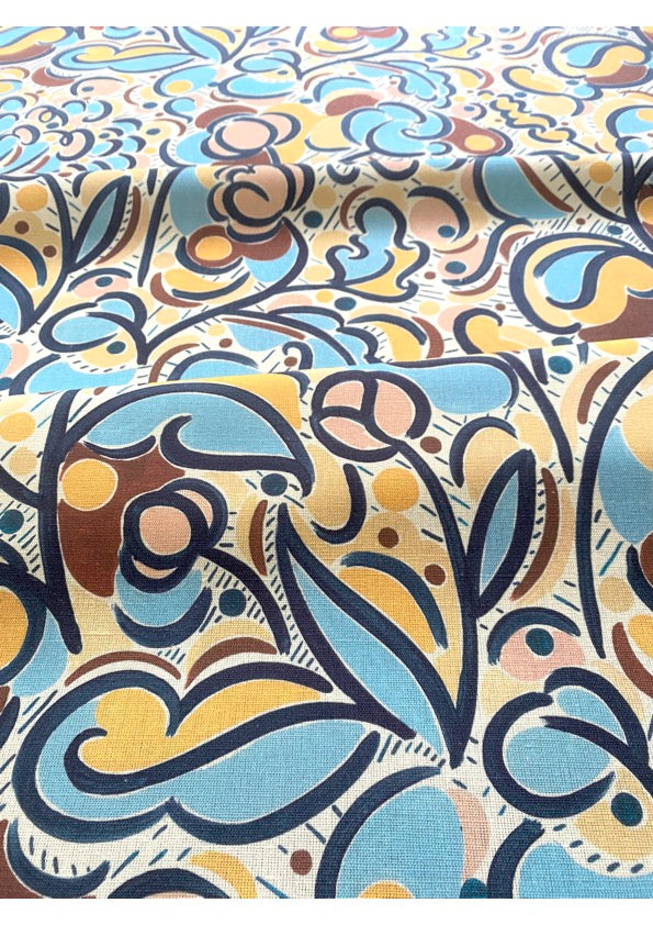 A fabric with a multicolored abstract pattern featuring various geometric and floral designs in shades of blue, maroon, orange, pink, and other colors.