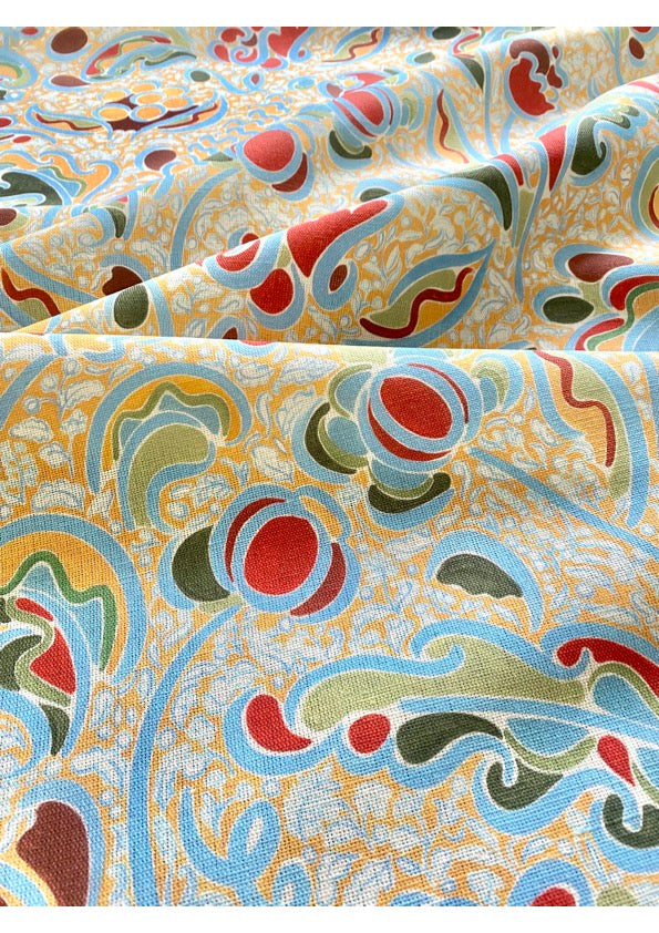A fabric with a vibrant multicolored floral pattern, consisting of beige, blue, green, orange, and red colors, sold by the yard.