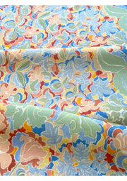 A fabric with a multicolored floral pattern featuring various colors such as beige, blue, green, pink, and yellow.