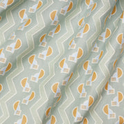 A close-up view of a fabric with a geometric pattern featuring stripes and shapes in blue, white, and yellow colors.