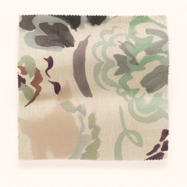 A piece of fabric with a floral pattern in beige, blush, green, and multi colors on a verdigris background.
