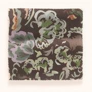 A yard of Bloomsbury Petite pattern fabric featuring a floral design in a mix of blue, brown, green, and purple colors on a brown background.