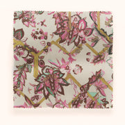 A piece of fabric with a floral pattern featuring pink, green, and yellow colors on a beige background.