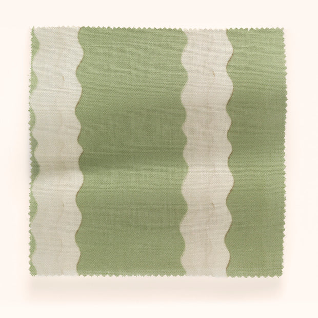 A piece of fabric with a double scroll stripe pattern in beige and green colors.