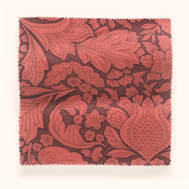 A swatch of red and brown floral patterned fabric.