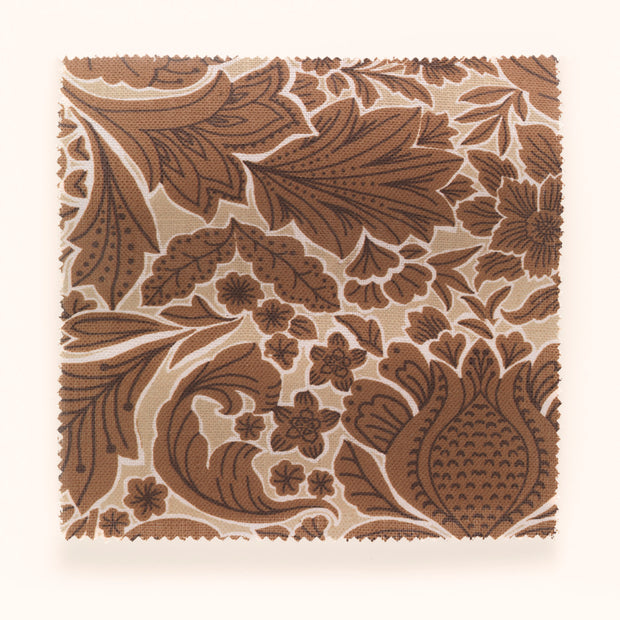 A yard of beige and brown floral patterned fabric.