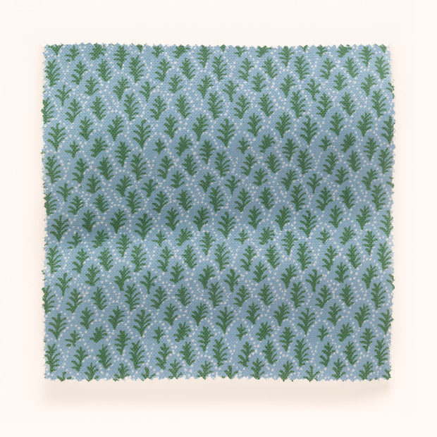A yard of fabric with a blue and green microprint of tree patterns.
