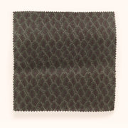 A swatch of fabric featuring a microprint geometric pattern in brown and green tones.