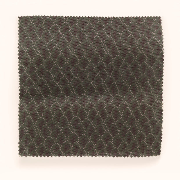 A swatch of fabric featuring a microprint geometric pattern in brown and green tones.