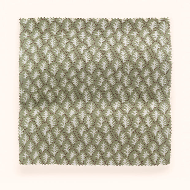 A swatch of pistachio-colored fabric with a tree pattern.
