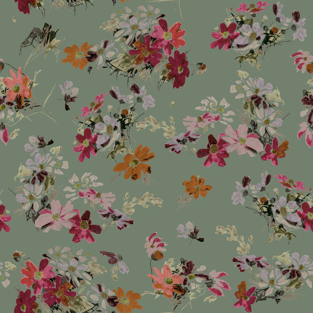 A wallpaper with a floral pattern featuring various colors including pink, red, orange, and lilac on a green background. Flowery Fields Wallpaper – Pine | Refreshing Floral Wall Mural by Roll