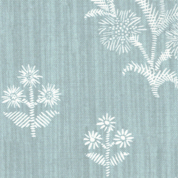 A section of fabric featuring a light blue background with white floral patterns, resembling cornflowers, repeated over the surface.