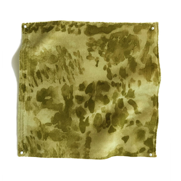 A swatch of heather velvet fabric in various shades of green, olive, and yellow with a textured finish.