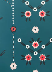 A section of wallpaper with a green background and a floral pattern consisting of red and white flowers and green leaves.