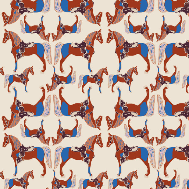 Yard fabric with a geometric horse pattern in beige, blue, and brown colors on a cream background.