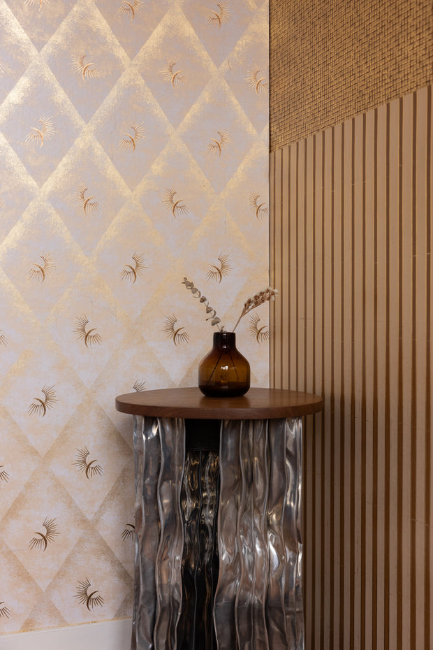 Decorative table with a vase against a patterned wall