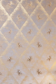 Beige quilted fabric with embroidered patterns