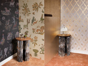 Decorative room with patterned wallpaper and marble-like pedestal tables.