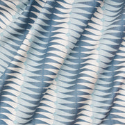 Close-up view of a fabric with a geometric stripe pattern in blue and white.