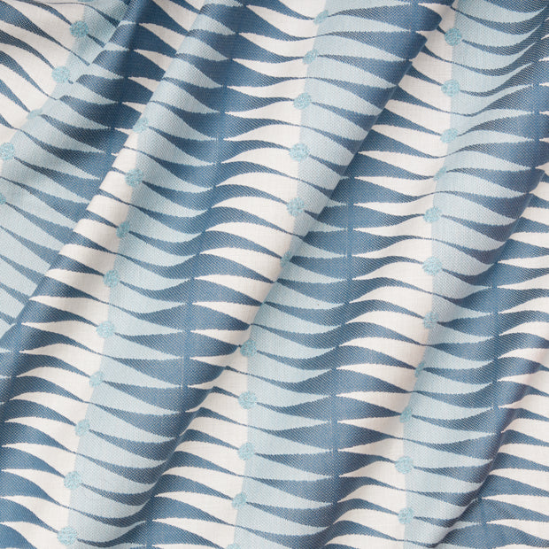 Close-up view of a fabric with a geometric stripe pattern in blue and white.