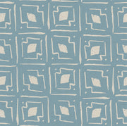 A blue fabric with a geometric pattern of interlocking shapes.