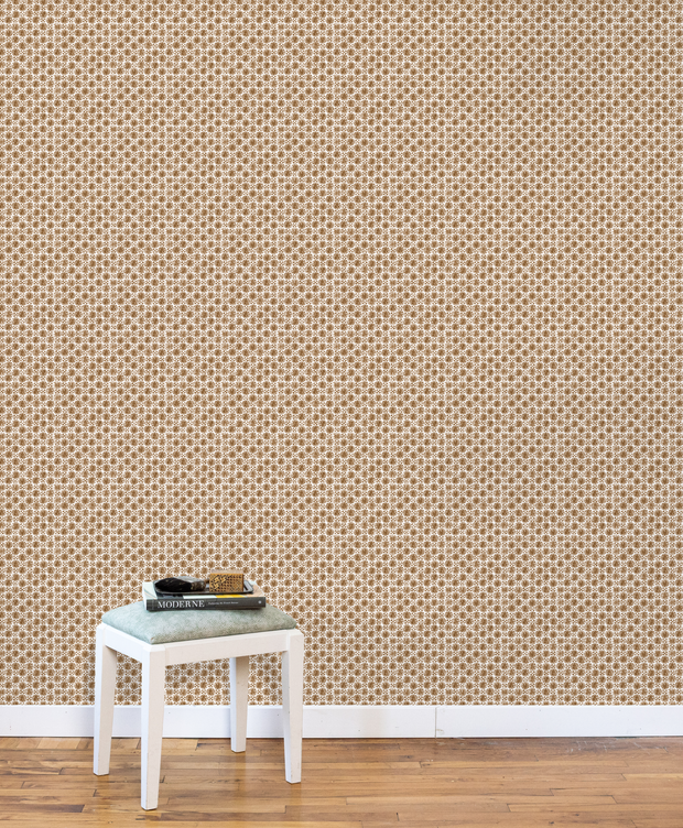 Beige wallpaper with subtle pattern, white baseboard, and wooden floor. Copper - Madras Geo Wallpaper by Panel