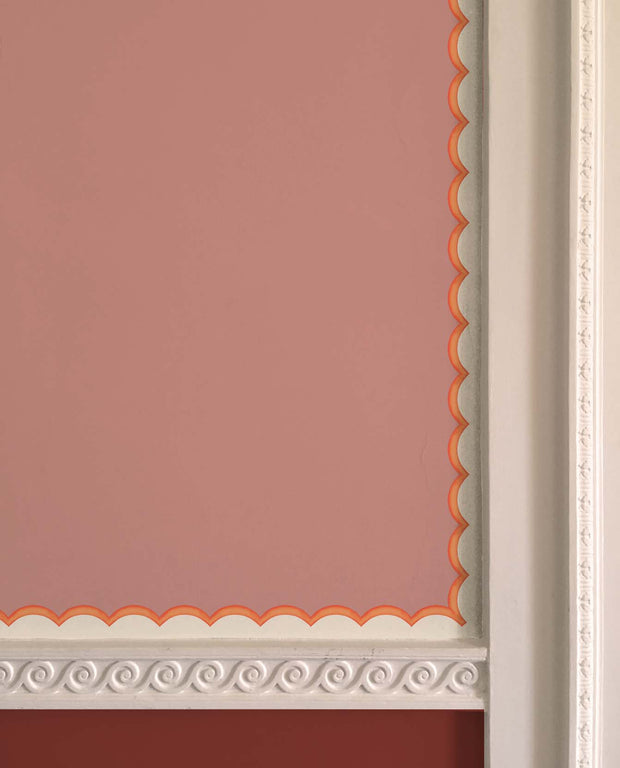 A wallpaper border with scalloped trim in orange, shown in a traditional style with a pink background and decorative elements - Orange - WP Scalloped Wallpaper Border, Non Woven, 10m Roll