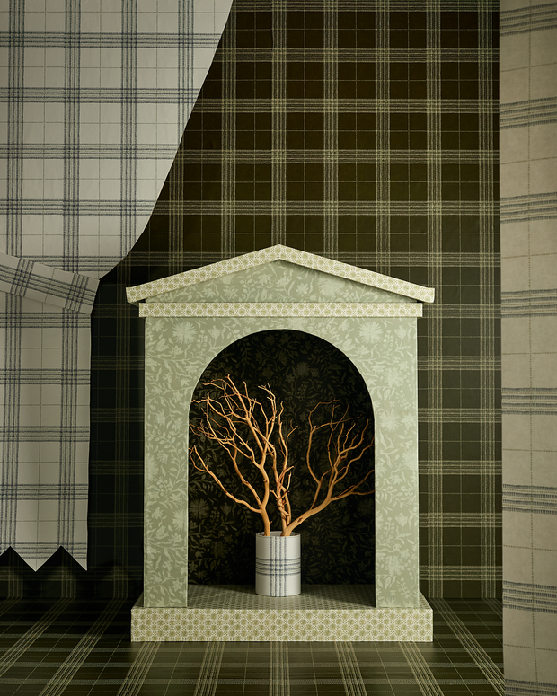 Decorative fireplace with a tree inside, surrounded by plaid-patterned wallpaper.