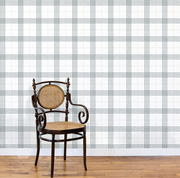 Wooden chair with a woven seat against a plaid wallpapered wall. Steelyard/Sage Wallpaper – Prairie Style Plaid | Modern Design