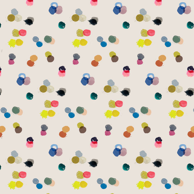 A wallpaper with a repeating pattern of colorful polka-dots on a beige background. Warm Bright - Play Day Wallpaper by Roll
