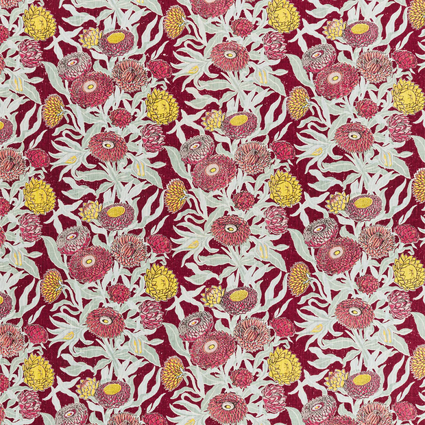 A piece of fabric with a floral pattern featuring red, yellow, and green colors on a maroon background.