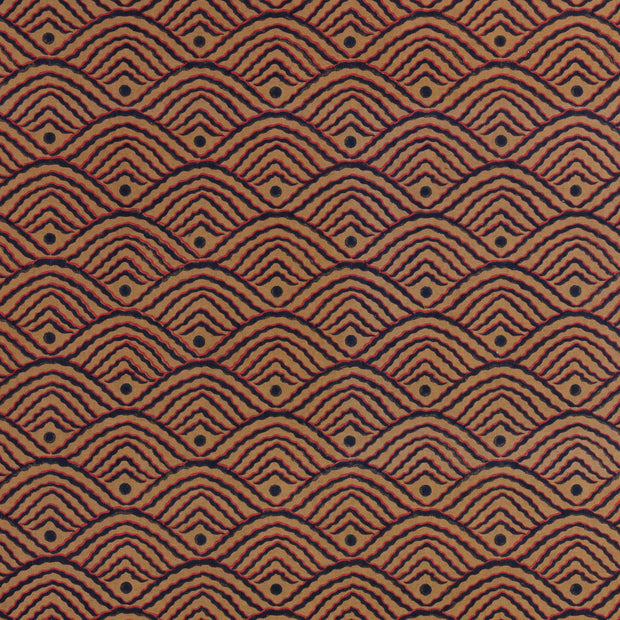 A close-up view of a textured fabric with a geometric pattern featuring shapes in a brown color.