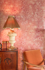 Decorative lamp on a wooden cabinet with bubble-patterned wall in the background