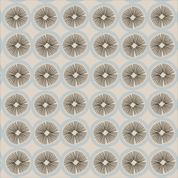 A fabric with a geometric pattern featuring circles and abstract designs in beige, black, and blue colors.