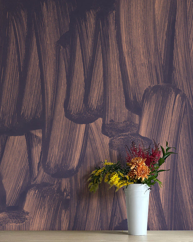 A wall adorned with purple and brown abstract wallpaper, featuring a white vase with multicolored flowers in front.