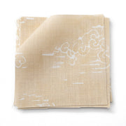 A folded piece of linen fabric with a white floral pattern on a beige background.