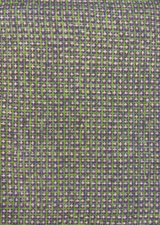 A close-up view of a fabric with a geometric pattern featuring green and grey colors.