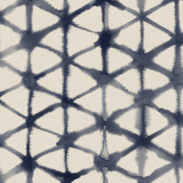 A section of wallpaper showing a geometric pattern with diamond shapes in a tie-dye style with varying shades of blue and beige on a white background - Morph Wallpaper – Indigo | Straight Match by Yard