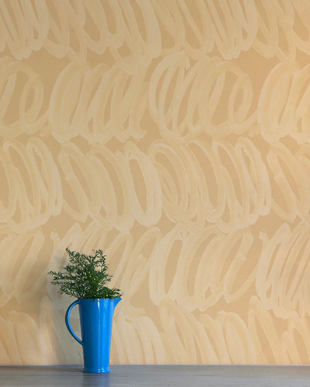 A section of wallpaper with a geometric pattern featuring circles in beige color, trimmed down to a 27-inch width, with a blue mug on the left side of the image - Nico Wallpaper – Whisper Collection | Non-Woven
