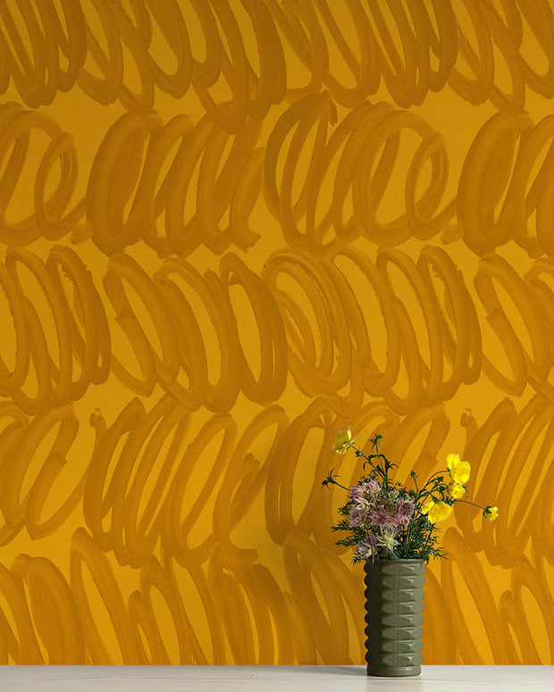 A wall adorned with orange wallpaper featuring a contemporary geometric pattern, with a vase of flowers in front - Supernova Wallpaper – Whisper Collection | Non-Woven