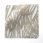 A yard of Windswept fabric with an abstract geometric pattern in beige, brown, gray, and white colors on a flat surface.