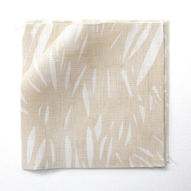 A yard of windswept beige and white flaxen fabric with an abstract pattern.