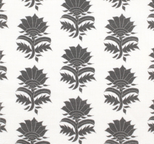 A fabric featuring a repeated geometric floral pattern in charcoal and white colors on a natural background.