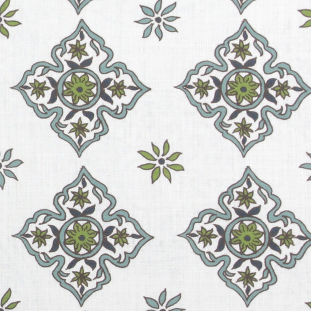 Fabric with a diamond and daisy geometric pattern in blue and green colors on a white background.