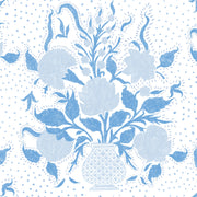 A blue fabric with a floral pattern featuring large blue flowers and smaller green leaves, with a repeat length of 23.69 inches by 13.